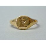 A gentleman's 9ct gold signet ring, the face bearing an intaglio armorial crest, 4.9g