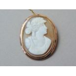 An early 20th Century shell cameo brooch, carved in depiction of a classical lady, rub set in a