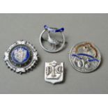 Four late 19th / early 20th Century enamelled white metal brooches, comprising one shield shaped