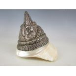 A South Asian white metal mounted sea shell, having punched, moulded and incised decoration