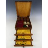 A 1930s oak cased Mah-jong set, with composition tiles, bone markers and dice, 22 x 25 x 15 cm high