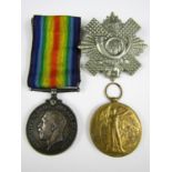 A British War and Victory medal pair to 37766 Pte E Wood, HLI, together with a cap badge