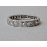 A high carat white metal and diamond set eternity ring, the diamond brilliants each of approximately