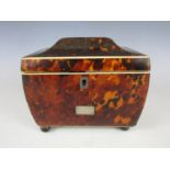 A Regency tortoiseshell tea caddy, of sarcophagus form with ivory and silver string inlay, opening