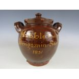 An early 19th Century slipware earthenware sugar pot, oviform with twin loop handles and cover, slip