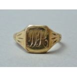 A 9ct gold signet ring, the rectangular face engraved with a monogram, and flanked by engraved