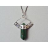 An early 20th Century Arts and Crafts style bloodstone and white metal pendant, the polished