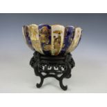 A 19th Century Japanese Satsuma bowl, decorated with panels of Geisha, mon mark to base, on hardwood