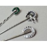 Three Victorian white metal lucky horseshoe stick pins, one set with polished malachite, test as