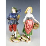 A pair of late 19th / early 20th Century porcelain figurines modelled respectively as a fruit and