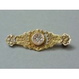 A Victorian 9ct gold and diamond Etruscan Revival bar brooch, centrally gypsy set with a diamond