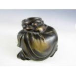 An early 20th Century novelty brass string box modelled as a crouched sleeping oriental figure or