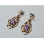 A pair of 9ct gold and amethyst ear pendants, each in an openwork pelleted arrangement, centrally