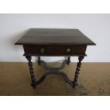 A late 17th Century oak writing table, having oblong top, frieze drawer with brass handles, and