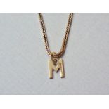 A 9ct gold 'M' initial pendant on a 9ct gold fancy link neck chain, 3.3g