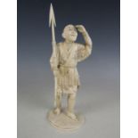 A Meiji Japanese sectional ivory okimono carved in depiction of a fisherman with harpoon, inset