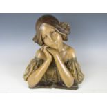 A Goldscheider style Art Nouveau painted terracotta bust of a young woman after Doebrich, depicted