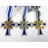 German Third Reich Mothers' Crosses respectively in bronze, silver and gold grades