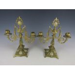 A pair of late Victorian two-branch brass candelabra by William Tonks and Sons, with design