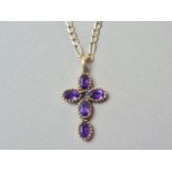 A 9ct gold and amethyst cruciform pendant necklace, the oval cut stones rub and pellet set in an