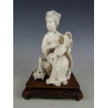 A Meiji Japanese single-piece ivory okimono carved in depiction of woman seated on a log holding a