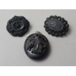 Victorian faux jet, comprising two carved brooches and a double locket, the latter of oval shape