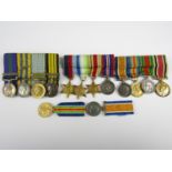 Four various Great War and later miniature medal groups