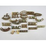 A quantity of British Army brass shoulder titles including T-RFA-HIGHLAND
