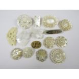 19th Century and later carved mother of pearl brooches and tokens, three brooches being carved in