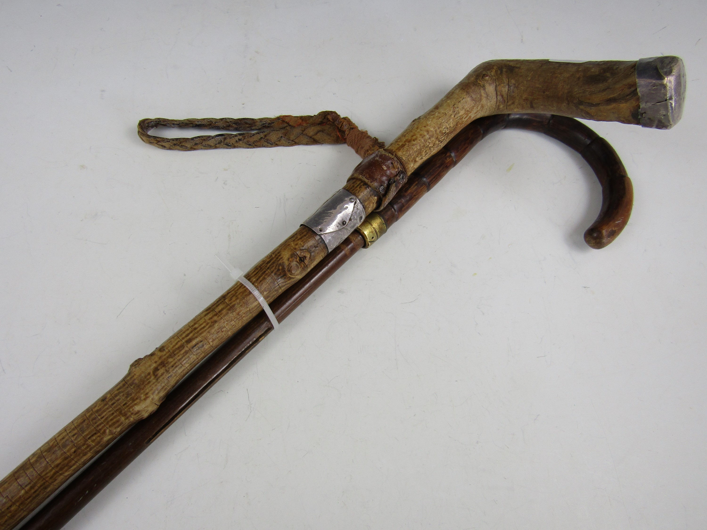 A vintage silver collared walking stick together with one other