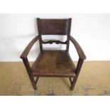 A George V leather upholstered oak armchair