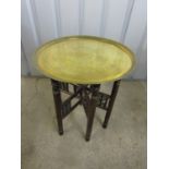 A brass topped circular table