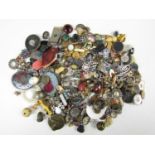 A large quantity of vintage costume jewellery parts, including silver and white metal monograms, and