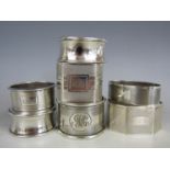 Selection of seven silver napkin rings each decorated with engine pattern