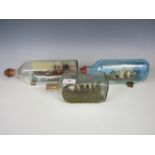Three vintage ship-in-a-bottle dioramas