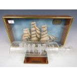 A glass ship-in-a-bottle depicting the SS Great Britain together with a cased scale model of the