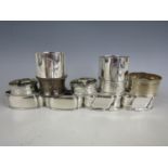 Two pairs of continental silver napkin rings together with two pairs of sterling silver napkin rings