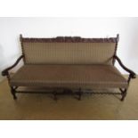 A 1920's carved and upholstered late 17th Century influenced oak settee, 190 cm (a/f)