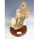 A Border Fine Arts figurine depicting an owl and two owlets on a tree stump, 28 cm