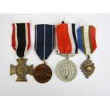A German Third Reich Bronze Honour Cross, two other European medals and a reproduction Canadian