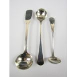 Two Georgian silver cruet spoons together with an American sterling spoon