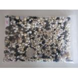 A large quantity of faux pearls and vintage glass and composition beads in black and white