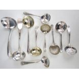 Nine various electroplate dredging spoons together with a pair of electroplate ladles