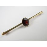 A 9ct gold and garnet bar brooch