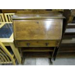 A 1920's oak bureau with presentation plaque dated August 25th 1924