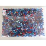 A large quantity of vintage glass and composition beads in tones of blue and red