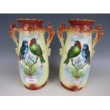 A pair of late 19th Century twin handled vases decorated with birds