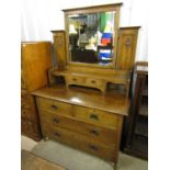 An Arts and Crafts style oak dressing chest