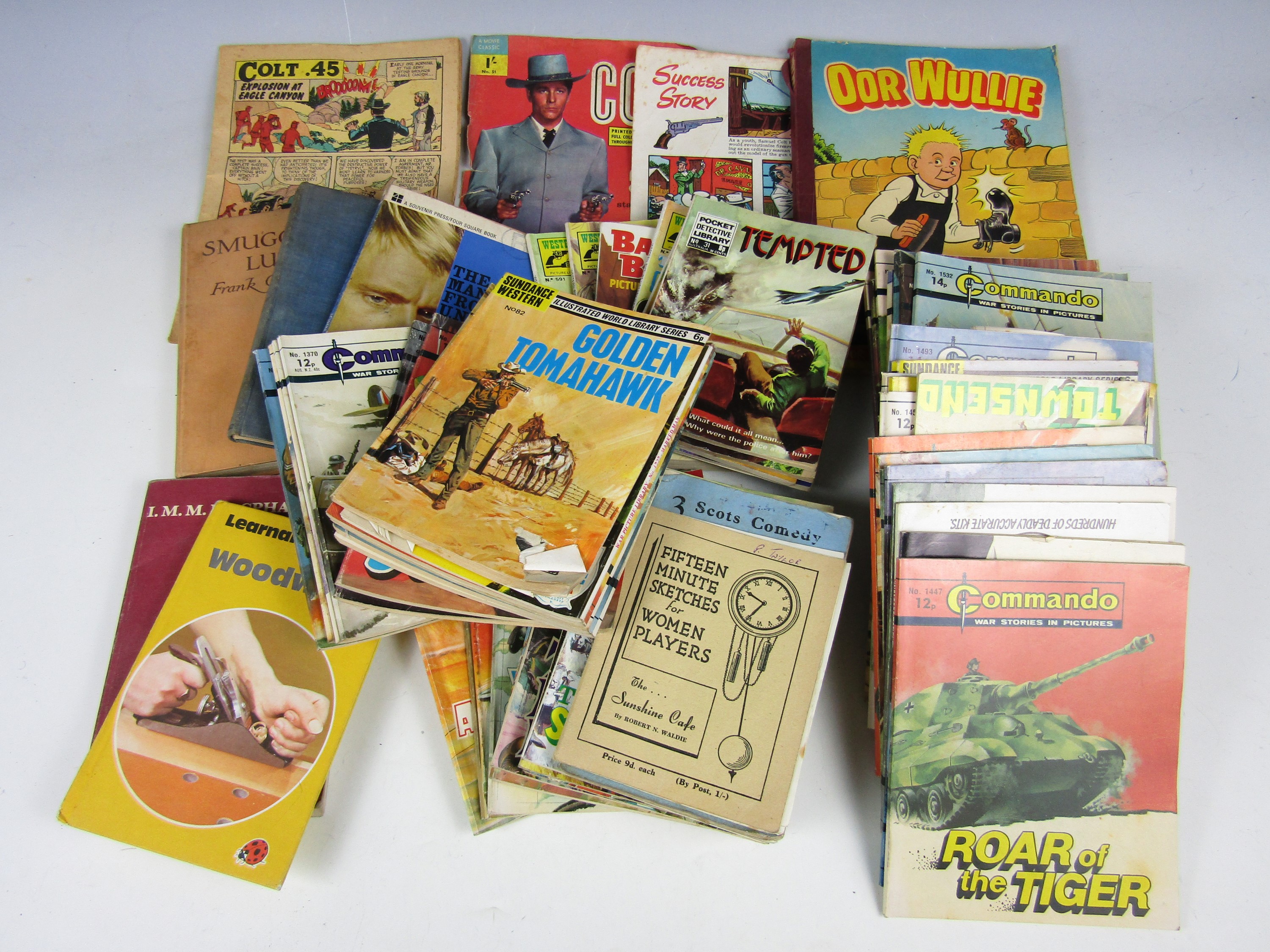 A large quantity of vintage annuals and books including Commando and Oor Wullie etc.