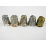 Three sterling silver thimbles together with brass advertising thimble 'Use Hudson's Soap' and one